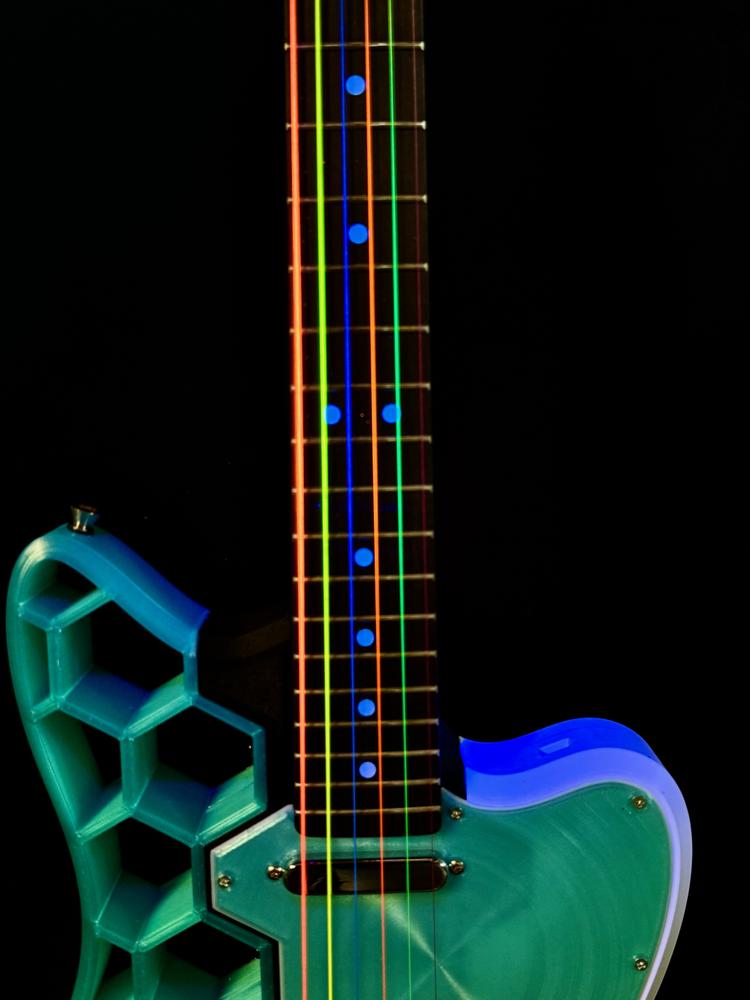 Telecaster-style guitar with UV-reactive rainbow strings